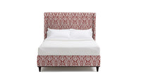 Upholstered Bed in fabric featuring a red and pink damask pattern.