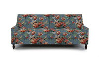 Sofa in Floral patterned fabric with red, white, and green  on a blue background