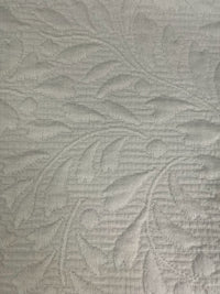 Textured fabric with leaf pattern in ivory tones