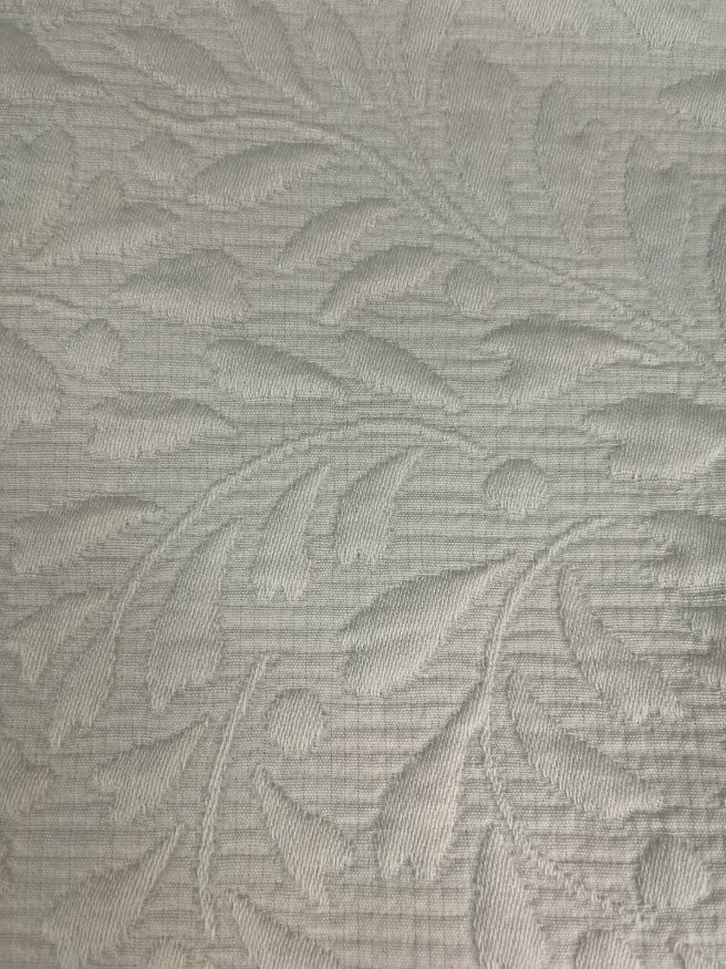 Textured fabric with leaf pattern in ivory tones