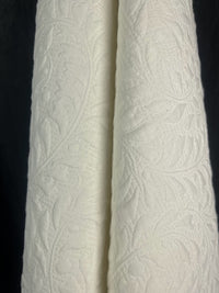 White textured fabric against a black background