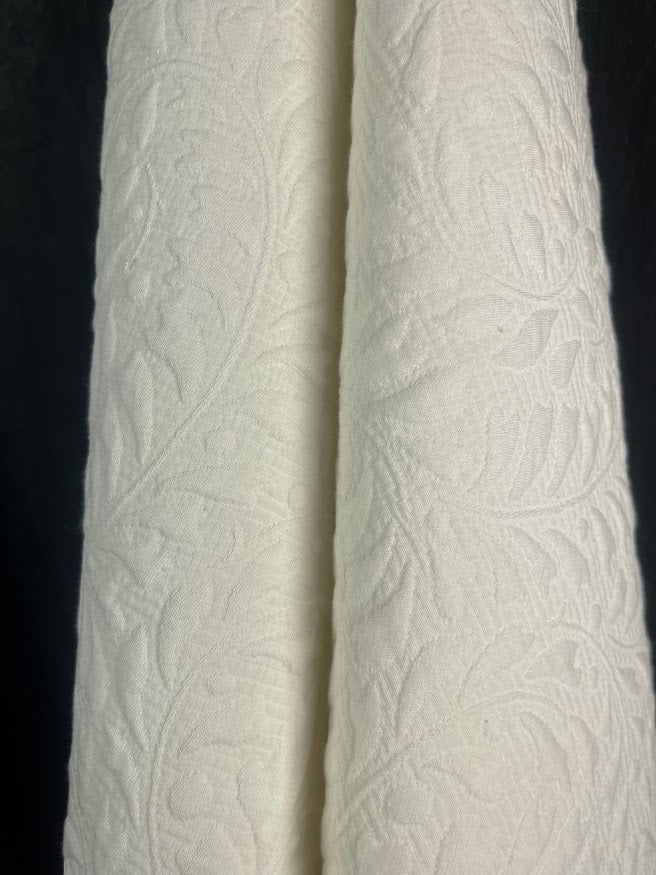 White textured fabric against a black background