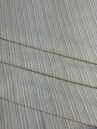 Beige striped fabric intended for use in home decor and upholstery.