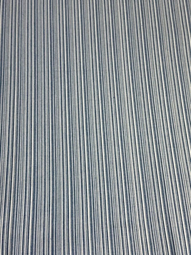 Close-up of fabric with thin vertical stripes in blue and white.