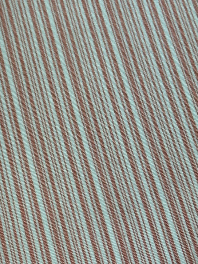 fabric featuring a small scale pink stripe pattern.