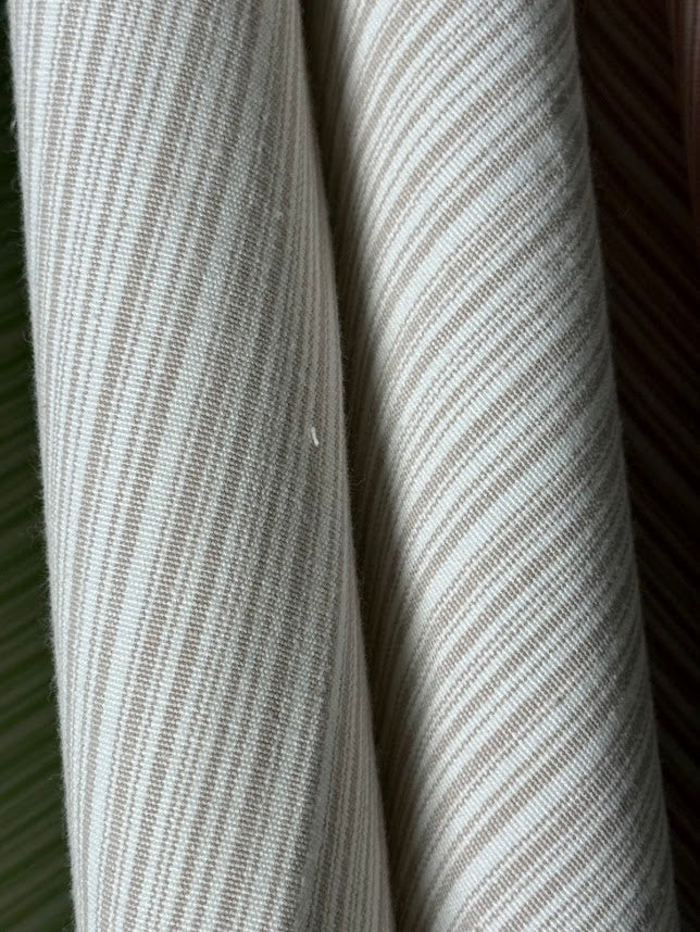  fabric featuring a small scale striped pattern in lavender tones