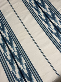 close up of blue embroidered stripe pattern with a geometric design.