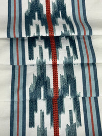 fabric featuring a striped pattern with embroidery in blue and red colors.
