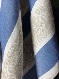 Fabric featuring a striped pattern with leaves in blue, taupe, and tan colors.