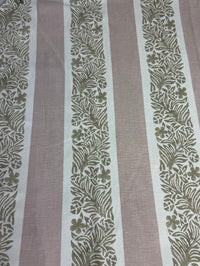 fabric featuring a striped pattern with varying shades of pink, purple, and white colors, with a leaf print design.
