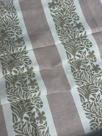 fabric featuring a striped pattern with varying shades of pink, purple, and white colors, with a leaf print design.