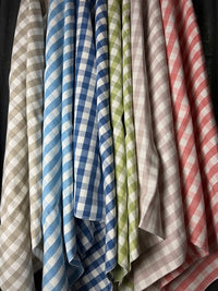 Collection of checkered cloths in various colors hanging together.