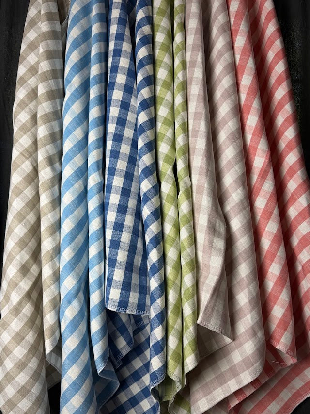 Collection of checkered cloths in various colors hanging together.