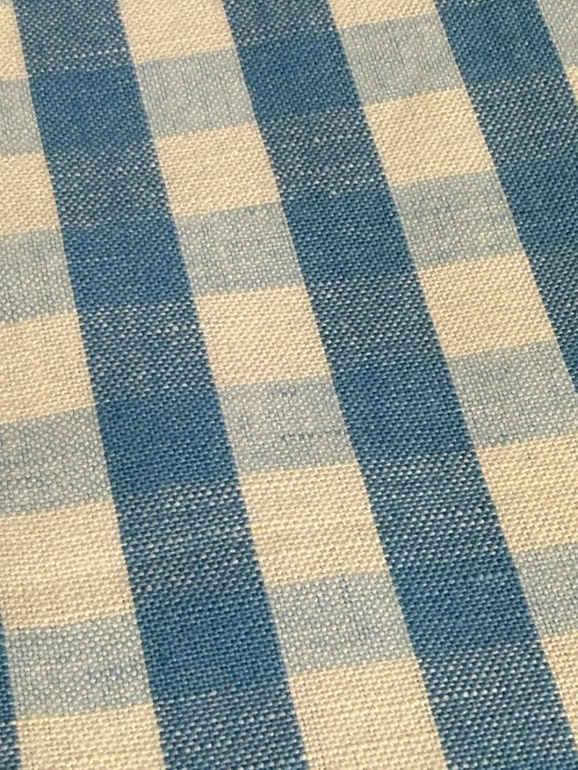 A close-up view of a fabric with a small checkered pattern in French Blue color.