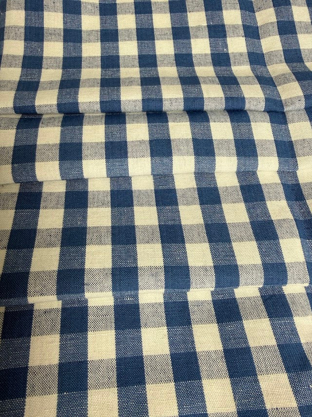 Roll of blue and white checkered fabric