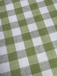 A close-up view of a fabric with a small checkered pattern in light green color.