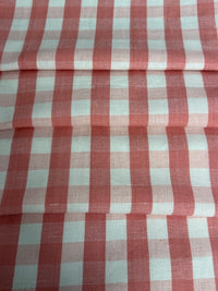 A close-up view of a pink checkered fabric pattern.