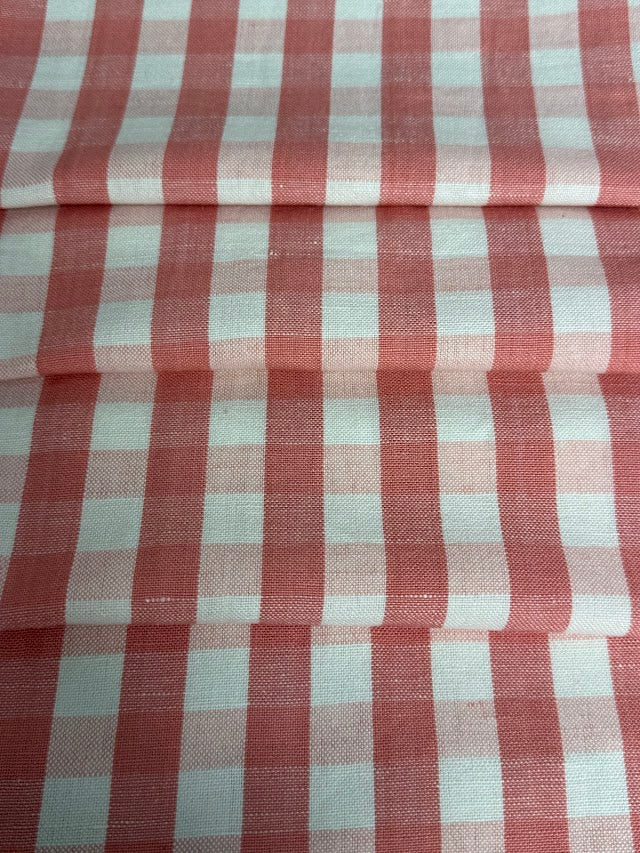 A close-up view of a pink checkered fabric pattern.