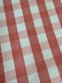 A close-up view of a pink checkered fabric pattern.