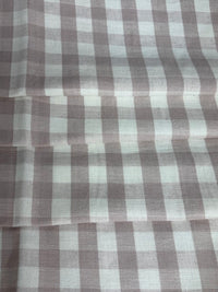 A close-up view of a fabric with a small checkered pattern in shades of lavender and purple.
