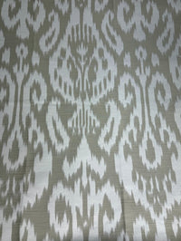 Fabric featuring a beige and cream damask pattern.