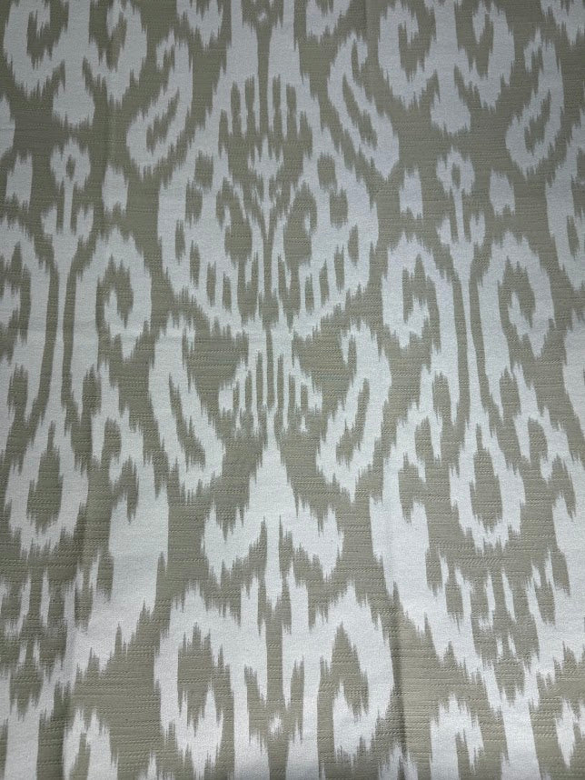 Fabric featuring a beige and cream damask pattern.