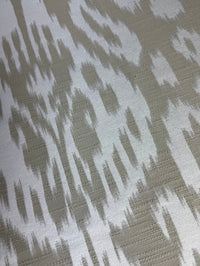 Fabric featuring a beige and cream abstract damask pattern.