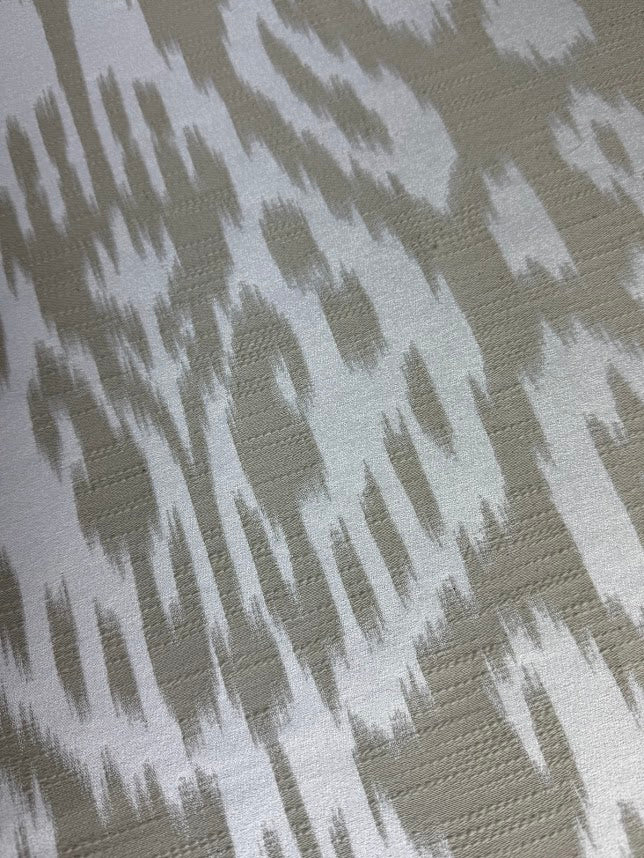 Fabric featuring a beige and cream abstract damask pattern.