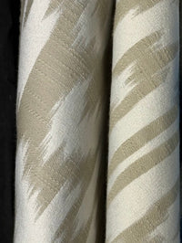 Fabric featuring a beige and cream damask pattern.
