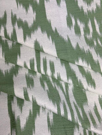fabric featuring a damask pattern in green color