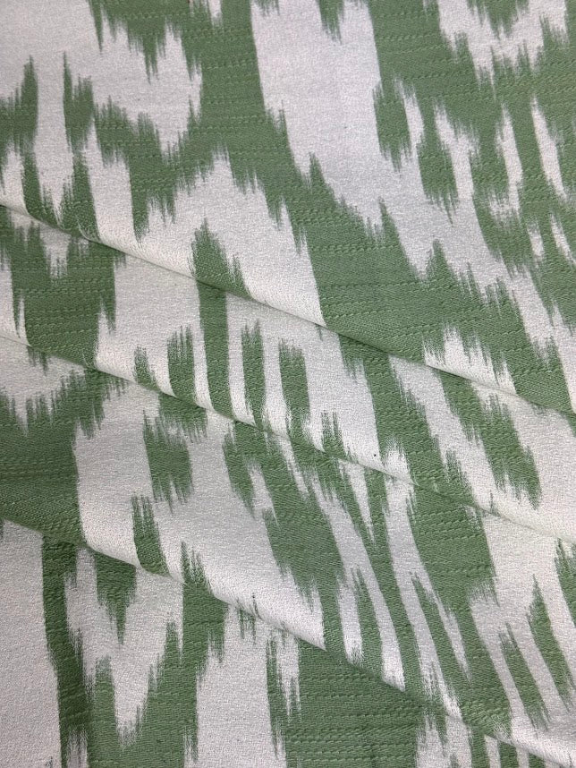 fabric featuring a damask pattern in green color
