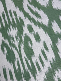 fabric featuring a damask pattern in green color, with a detailed and ornate design