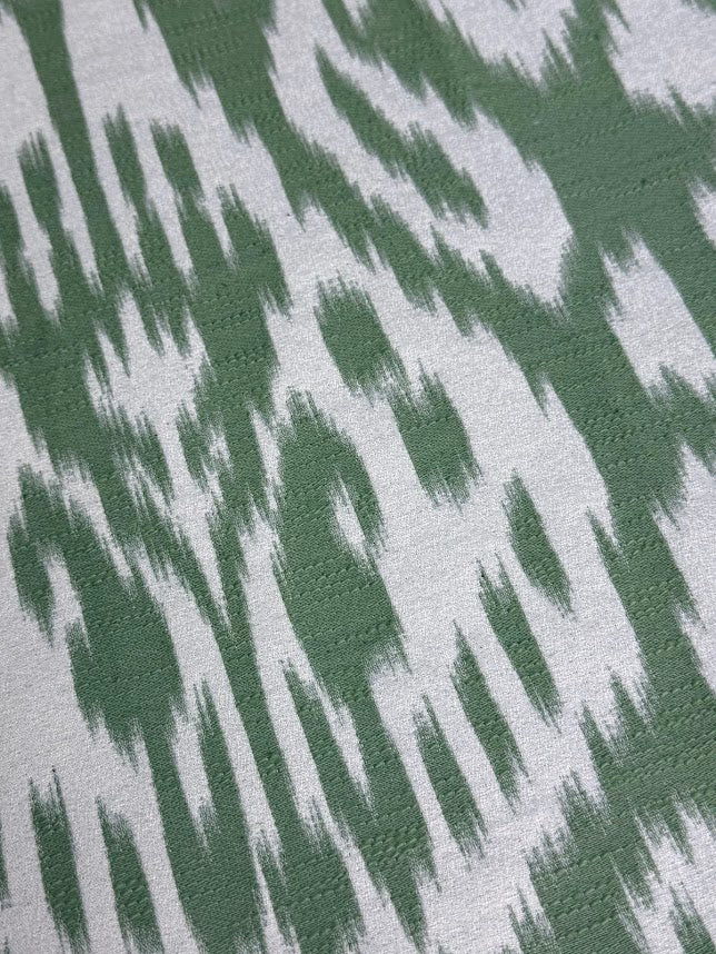 fabric featuring a damask pattern in green color, with a detailed and ornate design
