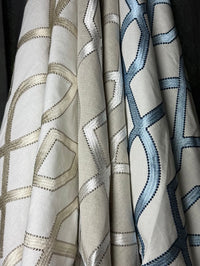 Close-up of fabric with geometric patterns in neutral colors.