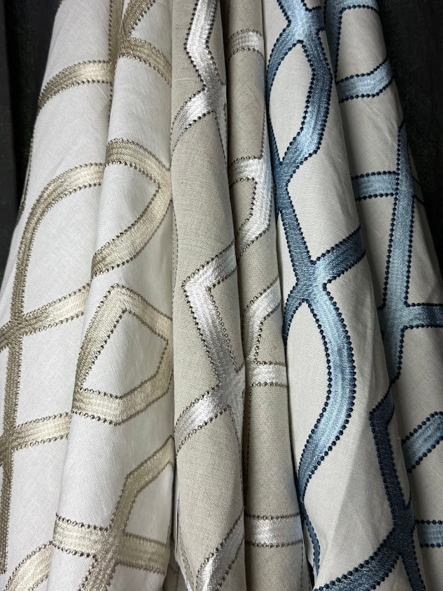 Close-up of fabric with geometric patterns in neutral colors.