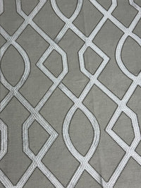 fabric featuring a geometric pattern with beige, taupe, and tan colors