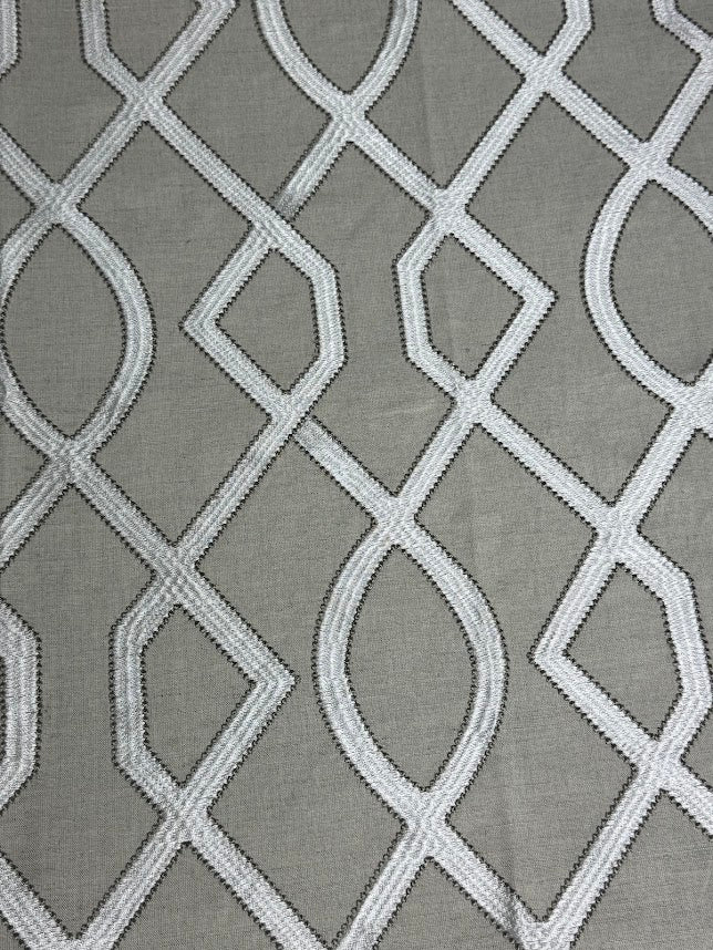 fabric featuring a geometric pattern with beige, taupe, and tan colors