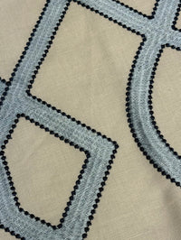 close up of fabric featuring a geometric pattern with blue and light blue colors.