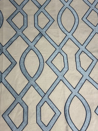 fabric featuring a geometric pattern with blue and light blue colors.