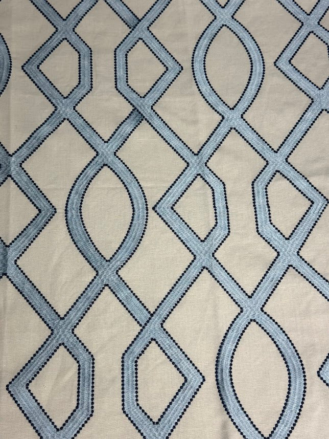 fabric featuring a geometric pattern with blue and light blue colors.