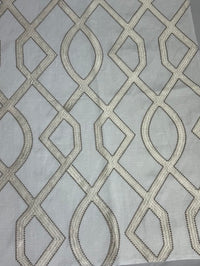fabric featuring a geometric pattern with beige and white colors.