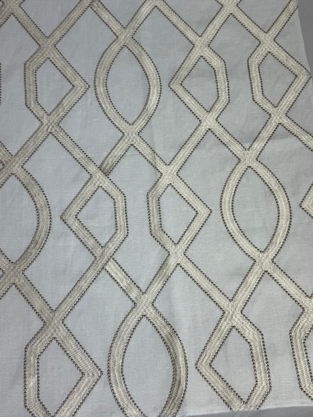 fabric featuring a geometric pattern with beige and white colors.