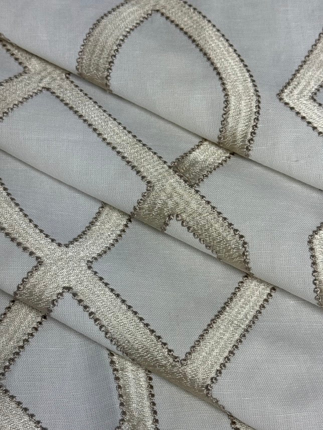 fabric featuring a geometric pattern with beige and white colors.