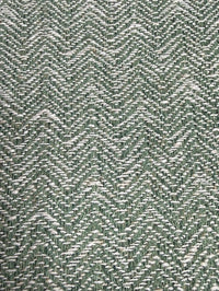 Close-up of a textured green fabric with a herringbone pattern