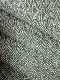 Close-up of a textured fabric with a herringbone pattern