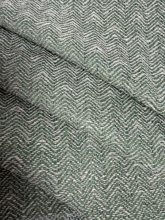 Close-up of a textured fabric with a herringbone pattern