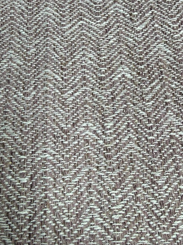 Textured fabric with a herringbone pattern in heather and white.