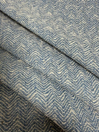 Close-up of blue herringbone fabric with a visible pattern