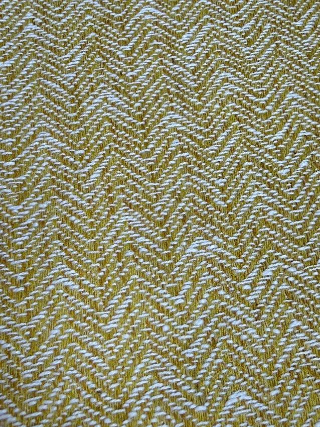 Textured fabric with a herringbone pattern in yellow and white