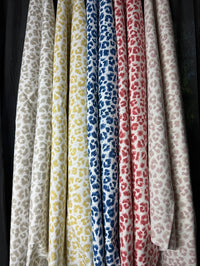 Five scarves with different animal print patterns on a black background